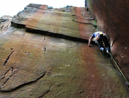 Climbing photography - Rossano Neroni climbing a beautiful gritstone corner,  Millstone, Peak District - England